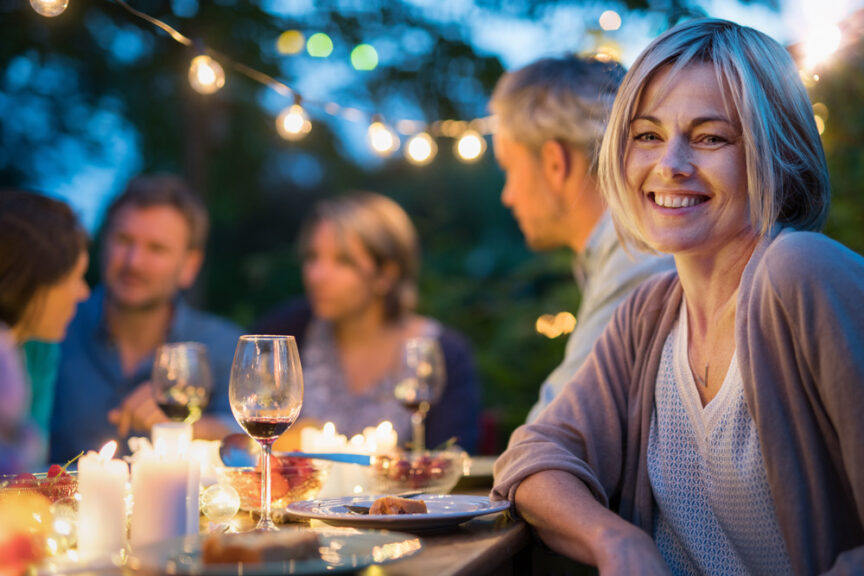 woman at outdoor dinner party with friends