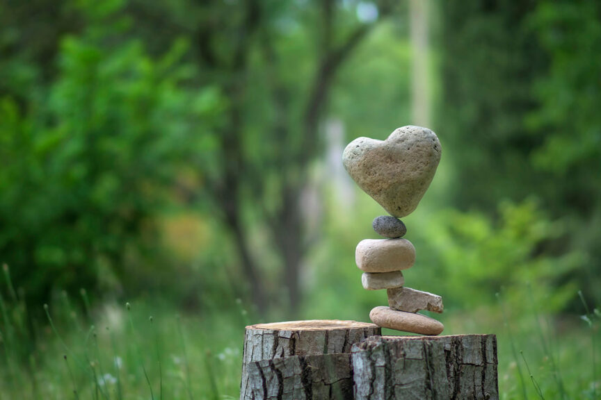 Stack of rocks with heart-shaped rock on top