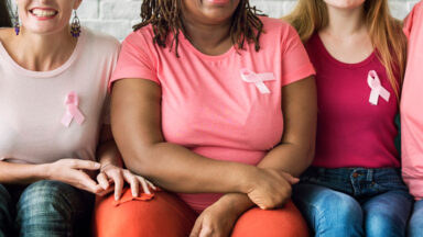 breast cancer awareness pink ribbons on group of women