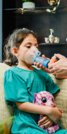 Female child receiving asthma treatment from a healthcare professional