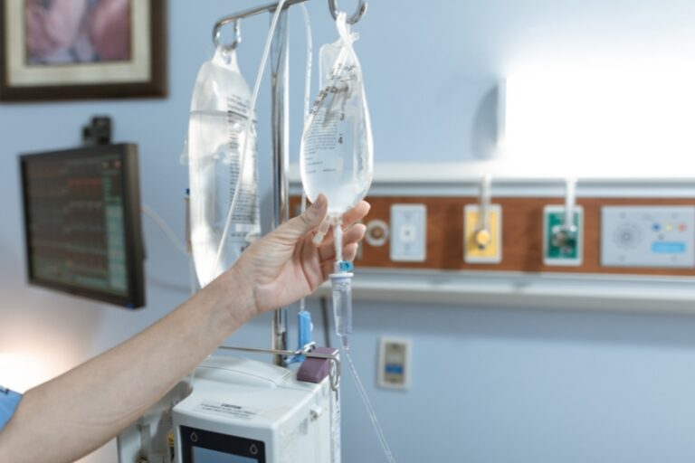 IV infusion bags in a clinical setting representing differences between biologic and infusion medications.