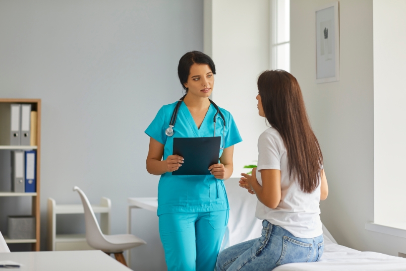 Nurse reviewing health information with a patient before infusion therapy.