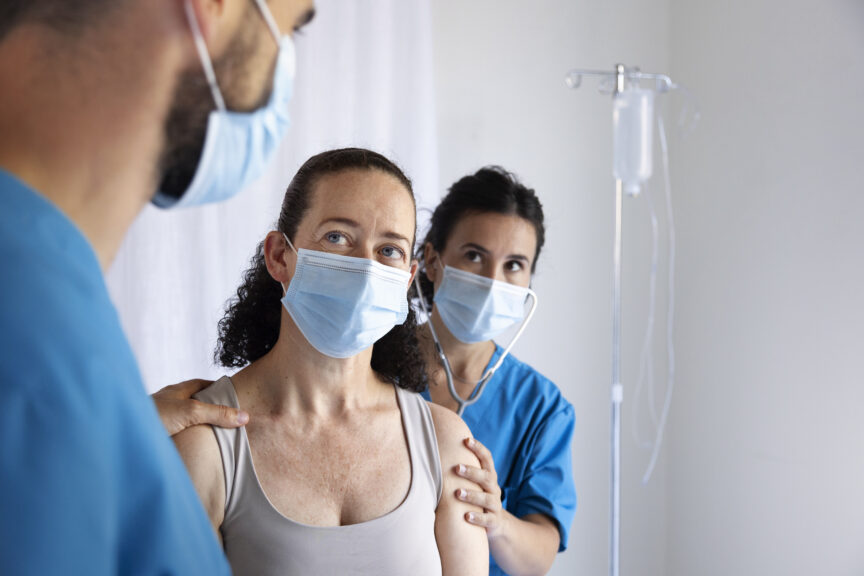Patient consulting with healthcare providers while deciding between infusion therapy and injection therapy.